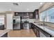 Well-equipped kitchen boasts stainless steel appliances, granite countertops, and dark cabinetry at 9541 Vast Valley Ave, Las Vegas, NV 89148