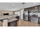 Bright kitchen with stainless steel appliances, dark cabinets, and granite countertops at 9541 Vast Valley Ave, Las Vegas, NV 89148