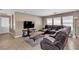 Cozy living room featuring a comfortable sectional sofa and a view of the TV at 9541 Vast Valley Ave, Las Vegas, NV 89148
