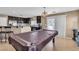 Open floor plan showing a living room area and kitchen space with dark cabinets at 9541 Vast Valley Ave, Las Vegas, NV 89148