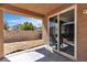 An empty patio space with a sliding glass door leading into the home's interior at 9541 Vast Valley Ave, Las Vegas, NV 89148