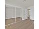 A bedroom with neutral walls, a large mirrored closet, and a doorway to another room at 9552 Gold Bank Dr, Las Vegas, NV 89134