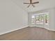 Spacious bedroom featuring a bay window, vaulted ceilings, ceiling fan, and laminate floors at 9552 Gold Bank Dr, Las Vegas, NV 89134