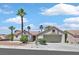 Charming single-story home with a two-car garage, desert landscaping, and mature palm trees at 9552 Gold Bank Dr, Las Vegas, NV 89134