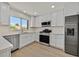 Modern kitchen featuring white cabinets, stainless steel appliances and light countertops at 9552 Gold Bank Dr, Las Vegas, NV 89134