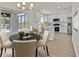 Eat-in kitchen featuring a black dining table with white chairs and white kitchen cabinets at 9552 Gold Bank Dr, Las Vegas, NV 89134
