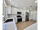 Modern kitchen featuring stainless steel appliances, white cabinets, and beautiful quartz countertops at 9552 Gold Bank Dr, Las Vegas, NV 89134