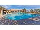 Outdoor pool and sun deck area with seating and a well-maintained pool, surrounded by lush landscaping at 9552 Gold Bank Dr, Las Vegas, NV 89134