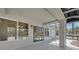 Covered patio featuring tiled floors, screened windows, and backyard views at 9552 Gold Bank Dr, Las Vegas, NV 89134