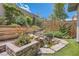 Landscaped backyard with a beautiful rock waterfall feature and lush greenery at , Henderson, NV 89011