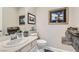 Clean bathroom with a white vanity, framed art, decorative accent, and neutral paint at , Henderson, NV 89011