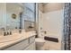 Well-lit bathroom featuring a shower-tub combo and a vanity with a white countertop and decor at , Henderson, NV 89011