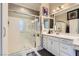 Bathroom featuring a glass-enclosed shower, white vanity, neutral paint, and tile floors at , Henderson, NV 89011