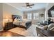 Comfortable bedroom with hardwood floors, ceiling fan, sitting chairs, and natural light at , Henderson, NV 89011