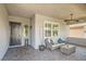 Inviting covered front porch with stylish seating, ceiling fan, and brick-paved flooring at , Henderson, NV 89011