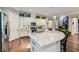 Bright kitchen with stainless steel appliances, white cabinets, granite counters, and hardwood floors at , Henderson, NV 89011