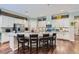 Gourmet kitchen with a large island, white cabinetry, stainless steel appliances, and hardwood floors at , Henderson, NV 89011