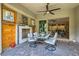 A covered patio has an outdoor dining area, a ceiling fan, and views of the interior of the house at , Henderson, NV 89011