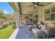 Inviting covered patio with a ceiling fan, fireplace, comfortable seating, and a view of the landscaped backyard at , Henderson, NV 89011