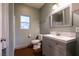 A well-lit bathroom featuring a single sink vanity with a mosaic tile backsplash and a mirrored medicine cabinet at , Las Vegas, NV 89131