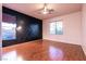Bedroom featuring wood floors, a decorative wall and two windows at , Las Vegas, NV 89131