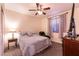 Comfortable bedroom featuring a ceiling fan, cozy queen bed, and side table with a decorative lamp at , Las Vegas, NV 89131