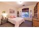 Comfortable bedroom featuring a large arched window and a decorative display shelf at , Las Vegas, NV 89131