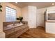 Step up to luxury with this tiled soaking tub and window in the primary bath at , Las Vegas, NV 89131