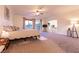 Spacious main bedroom with neutral carpet, ceiling fan, and access to attached bathroom at , Las Vegas, NV 89131