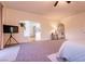 Large main bedroom featuring neutral carpet, ceiling fan, and a view into attached bathroom at , Las Vegas, NV 89131