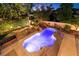 Backyard pool and spa with waterfall feature, lush landscaping and a built-in fire pit at , Las Vegas, NV 89131
