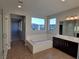 Bright bathroom featuring a soaking tub, double vanity, and tile flooring at 1027 Cambridge Park St, Las Vegas, NV 89148