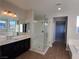 Bright bathroom with dual sinks, a soaking tub, and a glass-enclosed shower at 1027 Cambridge Park St, Las Vegas, NV 89148
