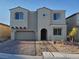 Two-story home featuring a neutral-colored stucco exterior and decorative brick driveway at 1027 Cambridge Park St, Las Vegas, NV 89148