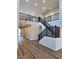 Grand foyer with staircase, dark wood railings, and wood-look floors leading to the main living areas at 1027 Cambridge Park St, Las Vegas, NV 89148