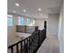 Well-lit upstairs hallway featuring black railings and carpet floors at 1027 Cambridge Park St, Las Vegas, NV 89148