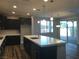 Modern kitchen features dark cabinetry, white countertops, an island, and stainless steel appliances at 1027 Cambridge Park St, Las Vegas, NV 89148