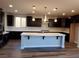 Modern kitchen featuring dark cabinets, an island with a white countertop, and stainless steel appliances at 1027 Cambridge Park St, Las Vegas, NV 89148
