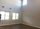 Sunlit living room with wood-look floors, and large windows for abundant natural light at 1027 Cambridge Park St, Las Vegas, NV 89148
