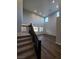 Bright living room with high ceilings, wood-look floors, and staircase with dark wood railings at 1027 Cambridge Park St, Las Vegas, NV 89148