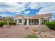 Back of the house with patio, desert landscaping, and serene yard features at 10513 Longwood Dr, Las Vegas, NV 89134