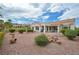Back of the house with serene desert landscaping, fountain, and covered patio at 10513 Longwood Dr, Las Vegas, NV 89134