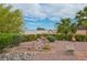 Beautiful backyard showing landscaping with rocks, green bushes and small stone waterfall at 10513 Longwood Dr, Las Vegas, NV 89134