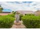 Landscaped backyard featuring a decorative stone fountain with lush greenery around desert style home at 10513 Longwood Dr, Las Vegas, NV 89134