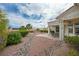 This covered patio overlooks a beautifully landscaped backyard with gravel, rocks and palm trees at 10513 Longwood Dr, Las Vegas, NV 89134