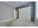 Gray bedroom featuring white carpet, a window, and a closet at 10513 Longwood Dr, Las Vegas, NV 89134