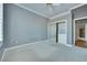 Gray bedroom with carpet, ceiling fan, and sliding mirror closet at 10513 Longwood Dr, Las Vegas, NV 89134
