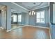 Bright dining room features wood-look tile flooring, white trim, grey walls, and mirror at 10513 Longwood Dr, Las Vegas, NV 89134