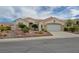 Inviting one-story home featuring a two-car garage and drought-tolerant landscaping at 10513 Longwood Dr, Las Vegas, NV 89134