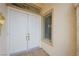 Elegant double front door with sidelight window and decorative trim at 10513 Longwood Dr, Las Vegas, NV 89134